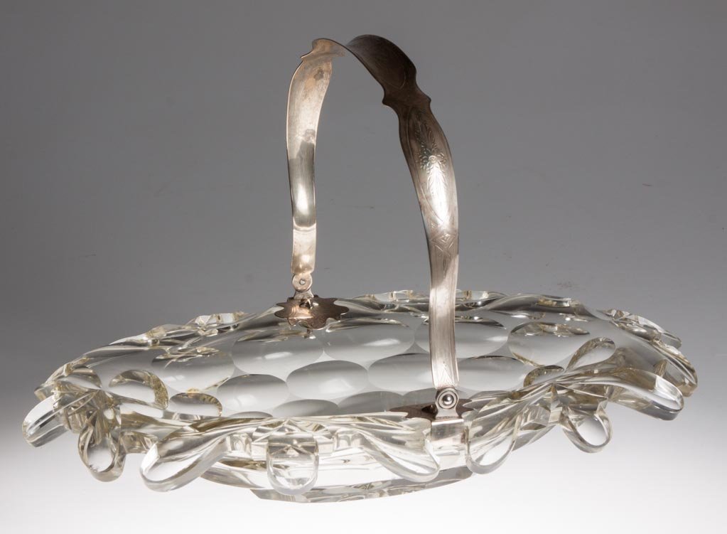EUROPEAN CUT GLASS LOAF TRAY: EUROPEAN CUT GLASS LOAF TRAY, colorless, fancy shaped rim, unmarked silver mounted bail handle of undetermined fineness. Second half 19th century. 9 1/2" HOA, 14 3/4" x 10" rim. Provenance: Property o