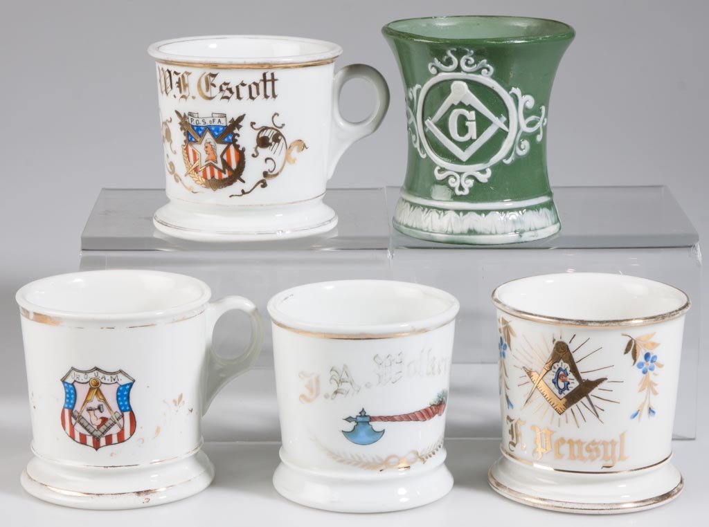 ASSORTED FRATERNAL PORCELAIN SHAVING MUGS, LOT OF FIVE: ASSORTED FRATERNAL PORCELAIN SHAVING MUGS, LOT OF FIVE, comprising three Masonic, one Patriotic Order Sons of America, and one with an ax having a Native American's head as the handle, three with owne