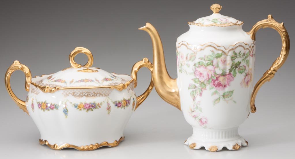 LIMOGES, FRANCE PORCELAIN SERVING ARTICLES, LOT OF TWO: LIMOGES, FRANCE PORCELAIN SERVING ARTICLES, LOT OF TWO, polychrome floral decorations with heavy gilding, comprising a two-handle biscuit jar with green J. Pouyat marks and Wanamaker's retailer mark,