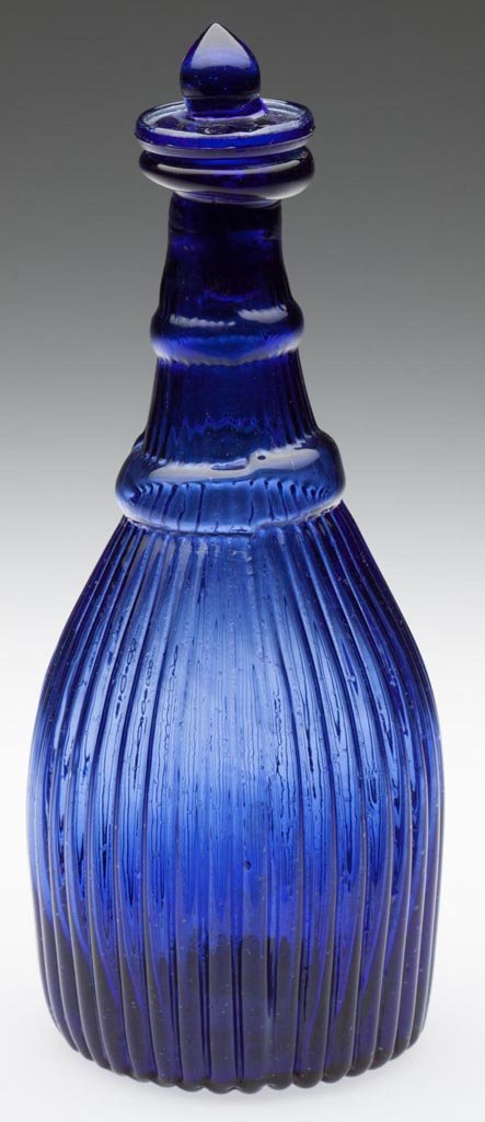 BLOWN-MOLDED GI-7 TYPE IV CRUET OR TOILET BOTTLE: BLOWN-MOLDED GI-7 TYPE IV CRUET OR TOILET BOTTLE, purple blue, crudely folded mouth, ribbed base with rough pontil mark, matching solid Tam-O'-Shanter stopper. Probably Boston & Sandwich Glass Co. 182