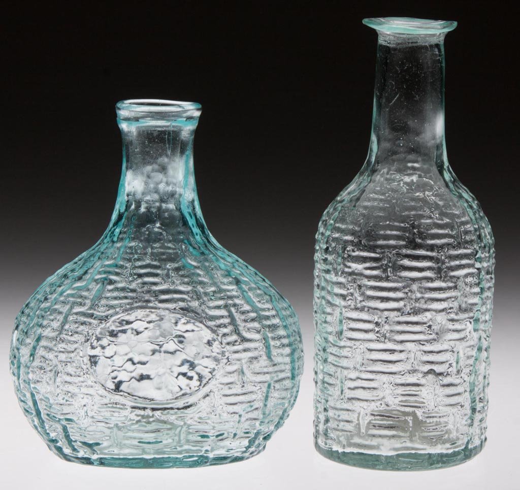 BLOWN-MOLDED WICKERED COMMERCIAL COLOGNE BOTTLES, LOT: BLOWN-MOLDED WICKERED COMMERCIAL COLOGNE BOTTLES, LOT OF TWO, aquamarine, comprising a demijohn form with rolled mouth and a cylindrical form with flange mouth, each with a rough pontil mark. Boston &