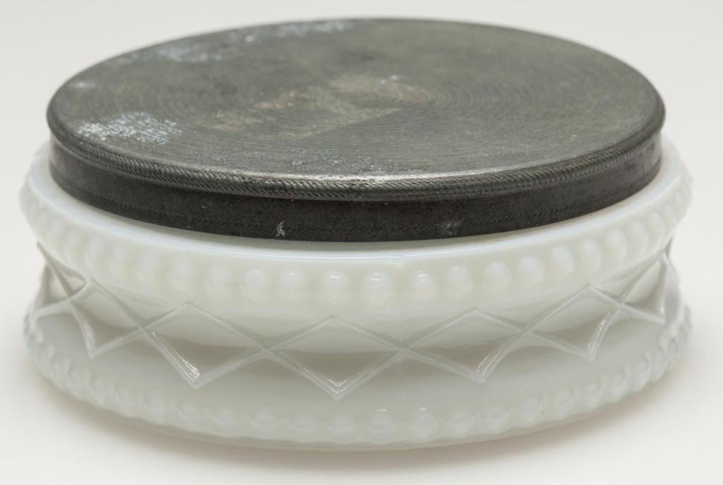 PRESSED OUTLINED DIAMOND WITH BEADING OINTMENT BOX: PRESSED OUTLINED DIAMOND WITH BEADING OINTMENT BOX, deep fiery opalescent, shallow circular form with plain base and appropriate Britannia cover. Boston & Sandwich Glass Co. and others. 1840-1860. 1" 