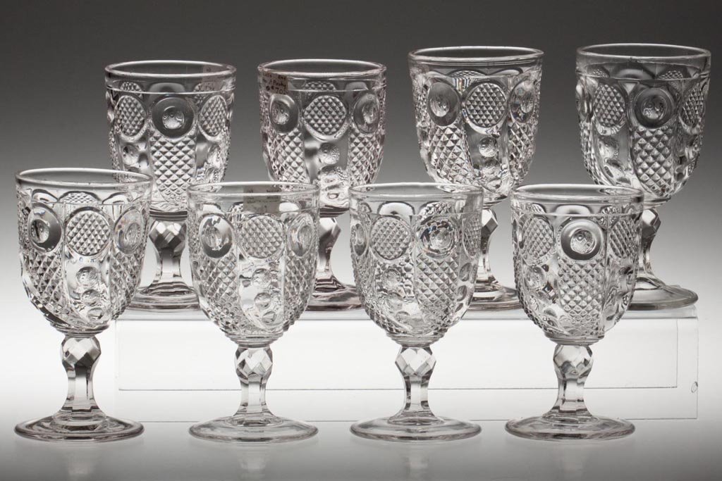 HORN OF PLENTY GOBLETS, LOT OF EIGHT: HORN OF PLENTY GOBLETS, LOT OF EIGHT, colorless lead glass, one with slight tint. Third quarter 19th century. 5 3/4" to 6 1/4" H. Provenance: Lillian "Lil" and Walter "Bud" Marchant Collection/Lil-Bud