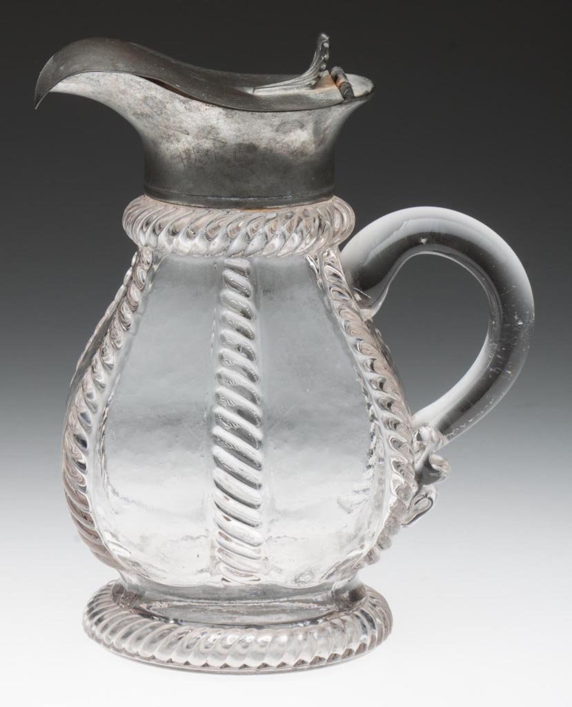 CABLE MOLASSES JUG / CAN: CABLE MOLASSES JUG / CAN, colorless lead glass, blown-molded pyrifrom body with applied solid handle, raised on a short drawn foot with patterned edge, original Britannia hinged lid with shell-form th