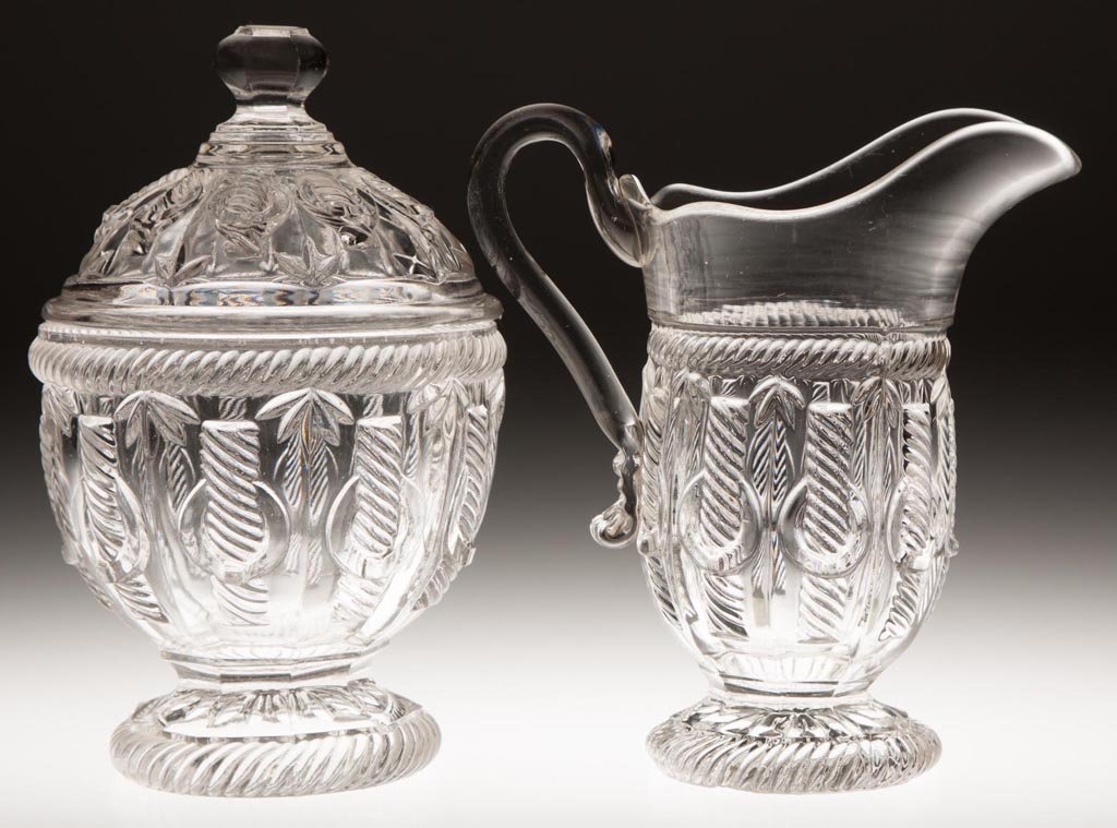 CABLE WITH RING TABLE ARTICLES, LOT OF TWO: CABLE WITH RING TABLE ARTICLES, LOT OF TWO, colorless lead glass, comprising a covered sugar bowl and creamer with applied handle. Third quarter 19th century. 7 1/2" and 6 5/8" HOA. Provenance: Collec
