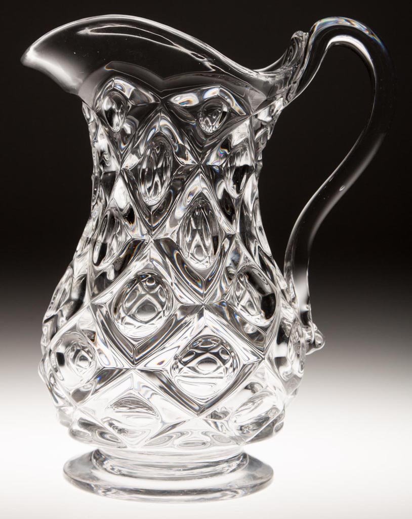 DIAMOND THUMBPRINT WATER PITCHER: DIAMOND THUMBPRINT WATER PITCHER, colorless lead glass, with applied handle and polished pontil mark. Third quarter 19th century. 9 5/8" HOA. Provenance: Collection of Jessie and the late Eugene Long,
