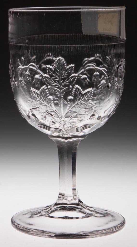 LILY-OF-THE-VALLEY CHAMPAGNE GLASS: LILY-OF-THE-VALLEY CHAMPAGNE GLASS, colorless. Fourth quarter 19th century. 4 7/8" H. Provenance: Lillian "Lil" and Walter "Bud" Marchant Collection/Lil-Bud Antiques.