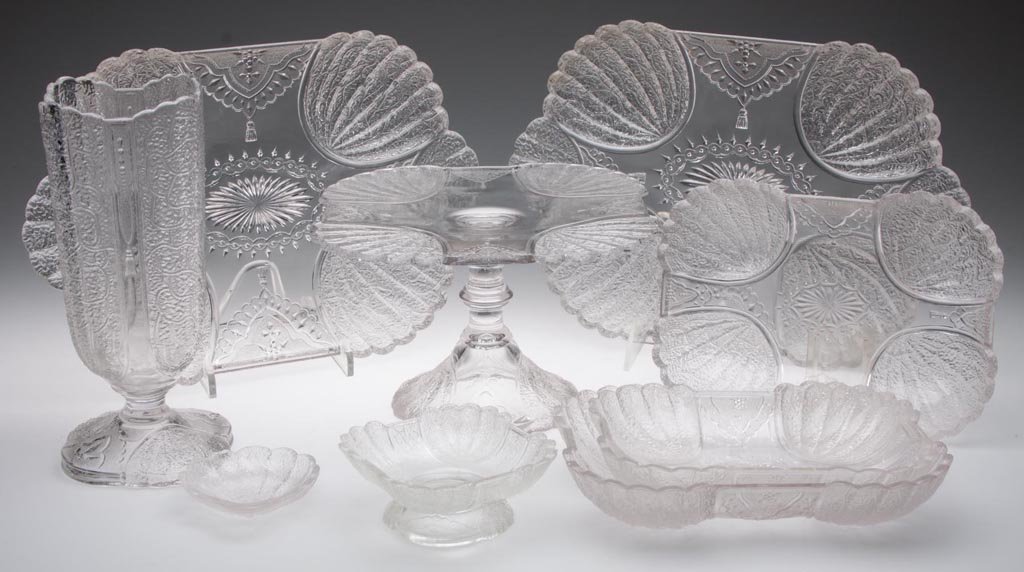 DUNCAN NO. 555 / SHELL AND TASSEL TABLE ARTICLES, LOT: DUNCAN NO. 555 / SHELL AND TASSEL TABLE ARTICLES, LOT OF NINE, colorless, including a celery, a salver / cake stand, and a small oblong dish with foliate engraving. Geo. Duncan & Sons. Pattern introdu