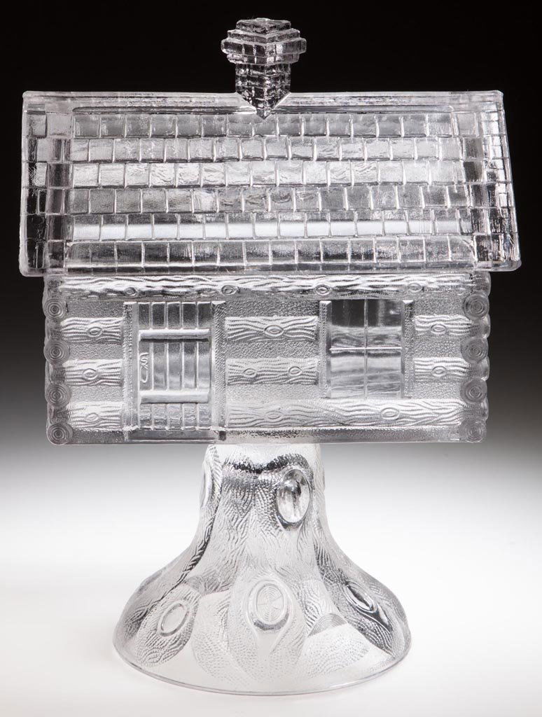 LOG CABIN COVERED COMPOTE: LOG CABIN COVERED COMPOTE, colorless, high standard. Central Glass Co. Fourth quarter 19th century. 9" HOA, 4 1/8" x 6". Literature: Hallock - Central Glass Company, p. 154. Provenance: From the Rudol