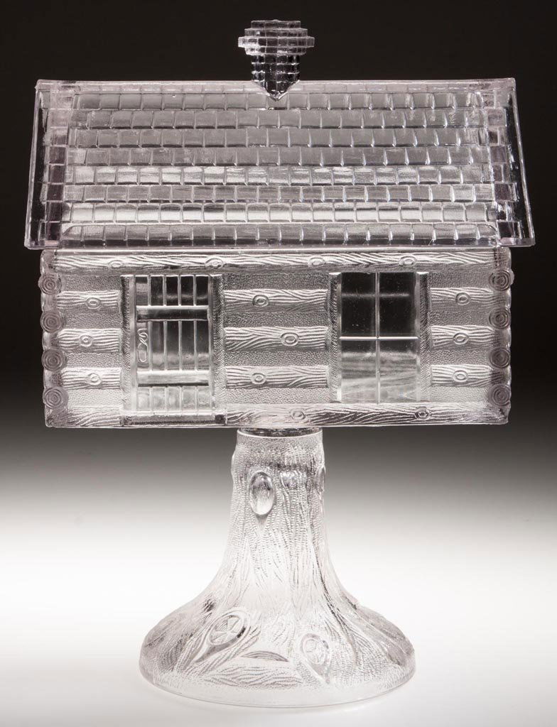 LOG CABIN COVERED COMPOTE: LOG CABIN COVERED COMPOTE, colorless, high standard. Central Glass Co. Fourth quarter 19th century. 11 5/8" HOA, 5 3/4" x 8". Literature: Hallock - Central Glass Company, p. 154. Provenance: From the