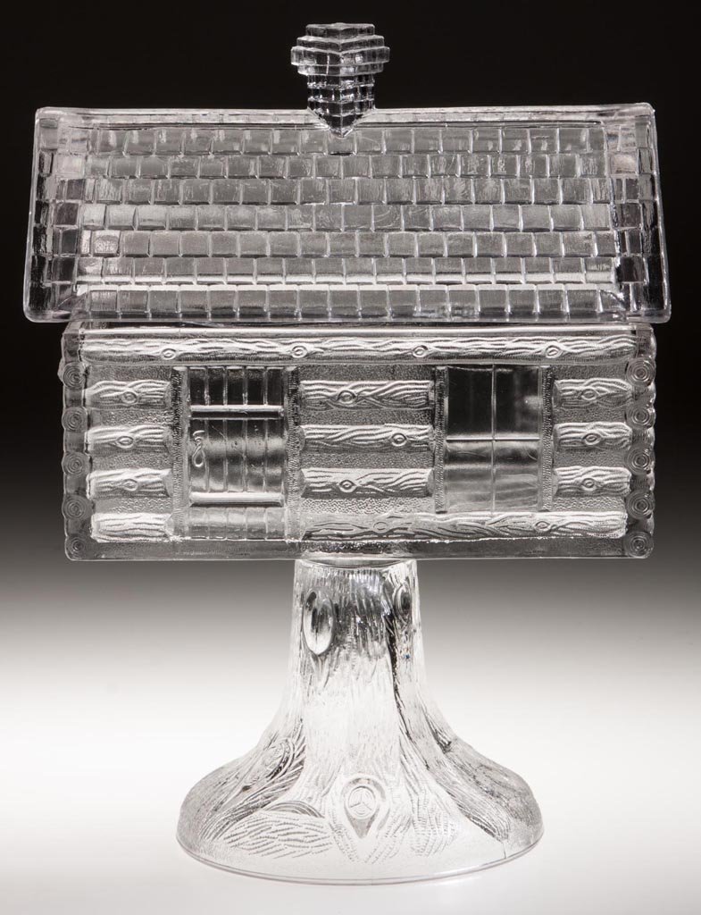 LOG CABIN COVERED COMPOTE: LOG CABIN COVERED COMPOTE, colorless, high standard. Central Glass Co. Fourth quarter 19th century. 10 1/2" HOA, 5" x 7". Literature: Hallock - Central Glass Company, p. 154. Provenance: From the Rudo