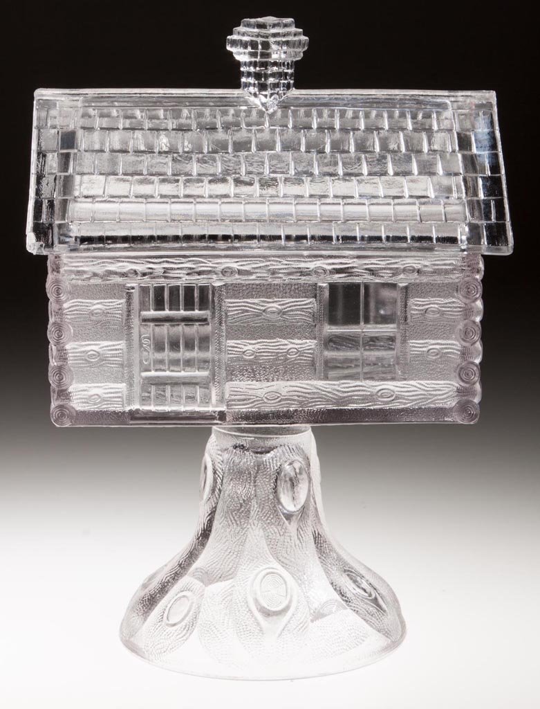 LOG CABIN COVERED COMPOTE: LOG CABIN COVERED COMPOTE, colorless, high standard. Central Glass Co. Fourth quarter 19th century. 9 1/4" HOA, 4 1/8" x 6". Literature: Hallock - Central Glass Company, p. 154. Provenance: From the R