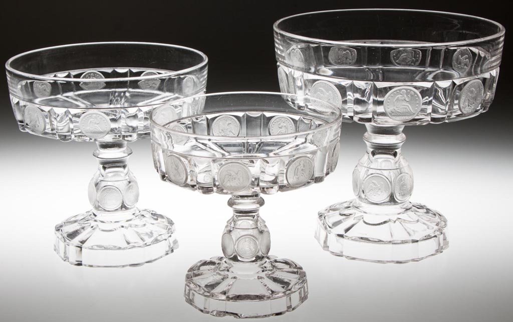 U. S. COIN OPEN COMPOTES, LOT OF THREE: U. S. COIN OPEN COMPOTES, LOT OF THREE, colorless with frosted coins, each featuring nine quarters and six dimes. Central Glass Co. Circa 1891-1892. 6" to 8" H, 6" to 7 7/8" D bowls. Provenance: From 