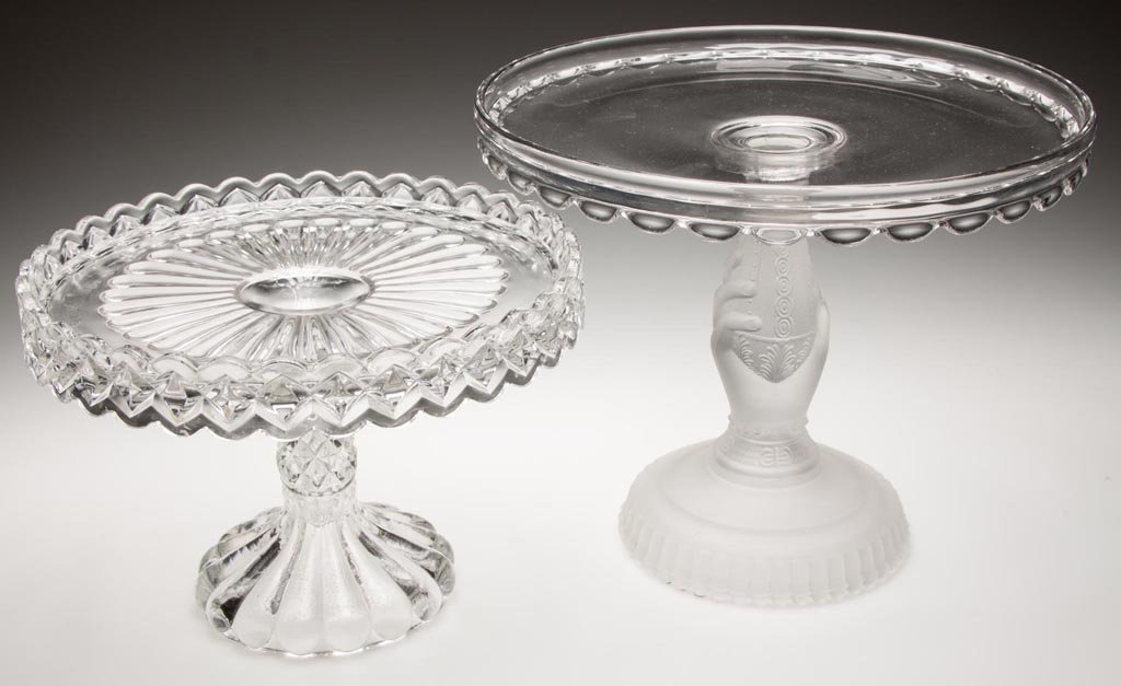ASSORTED EAPG CAKE STANDS, LOT OF TWO: ASSORTED EAPG CAKE STANDS, LOT OF TWO, colorless and frosted, including a Frosted Hand example. Fourth quarter 19th century. 6 3/8" to 8 1/2" HOA. Provenance: Collection of Jessie and the late Eugene 