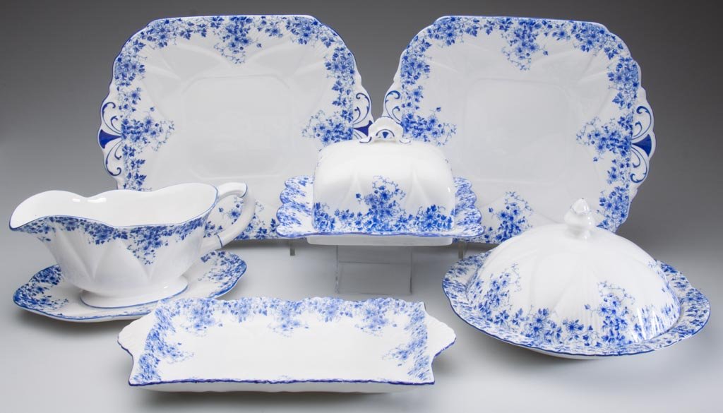 ENGLISH PORCELAIN SHELLEY CHINA LTD. "DAINTY BLUE" PATT: ENGLISH PORCELAIN SHELLEY CHINA LTD. "DAINTY BLUE" PATTERN "DAINTY" SHAPE TABLEWARE, LOT OF SEVEN ARTICLES, comprising a muffin dish and cover; a rectangular butter dish and cover; a low footed gravy 