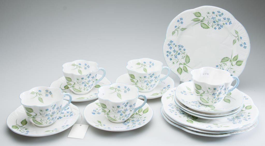 ENGLISH PORCELAIN SHELLEY CHINA LTD. "AMERICAN BROOKLIM: ENGLISH PORCELAIN SHELLEY CHINA LTD. "AMERICAN BROOKLIME" PATTERN "DAINTY" SHAPE TABLEWARE, LOT OF 16, including four plates, five cups and seven saucers, all with scallop-molded bodies, the floral pa