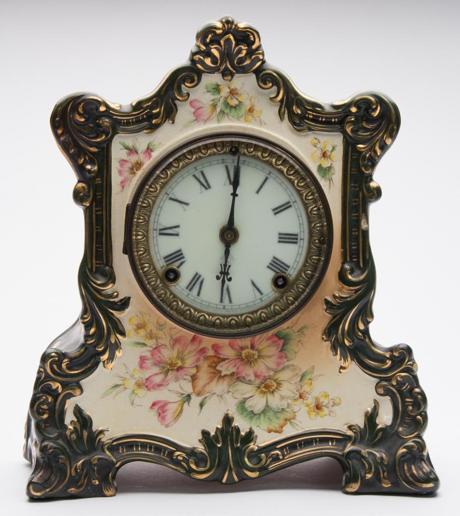 GERMAN POTTERY ROYAL BONN-TYPE CASED ANSONIA: GERMAN POTTERY ROYAL BONN-TYPE CASED ANSONIA MANTEL CLOCK, "WABASH" MODEL, the clock of swollen, ogee shape, with scroll-molding to sides and crest, on four feet, the center and sides printed and over