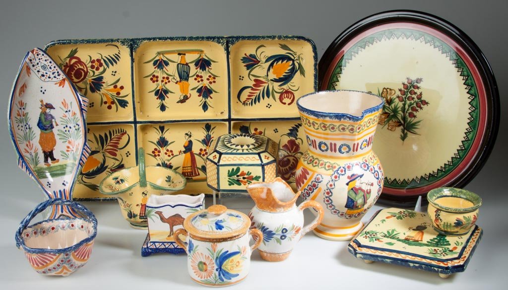 FRENCH ART DECO POTTERY QUIMPER "SOLEIL"-WARE ARTICLES : FRENCH ART DECO POTTERY QUIMPER "SOLEIL"-WARE ARTICLES LOT OF 12, INCLUDING A TRIVET; HORS D'OUVRE DIVIDED DISH, a squared inkwell and drum, a miniature chamber pot and basket; and a footed pitcher wi