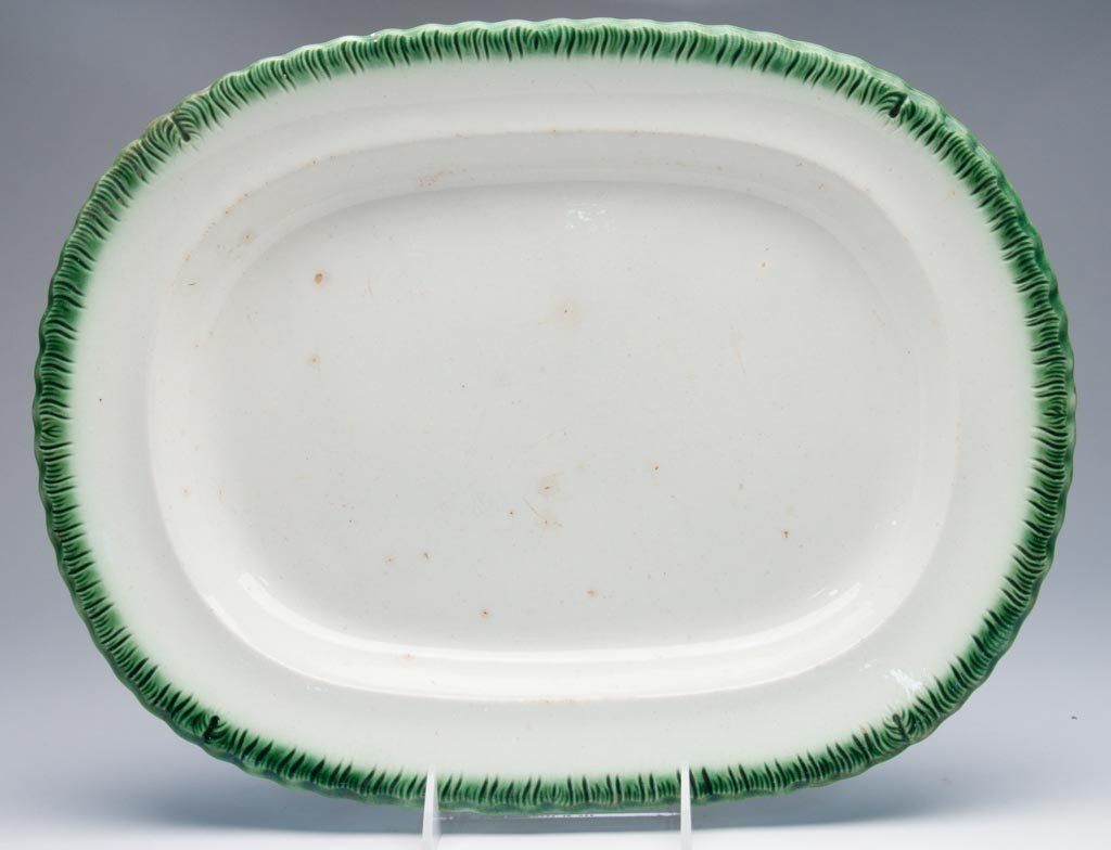 ENGLISH STAFFORDSHIRE LEEDS POTTERY SHELL- OR FEATHER-E: ENGLISH STAFFORDSHIRE LEEDS POTTERY SHELL- OR FEATHER-EDGED GREEN-RIMMED OVULAR PLATTER, 1820-1840. 15" h. Provenance: From the collection of the late Betty Jane Renn, Sunbury, PA.