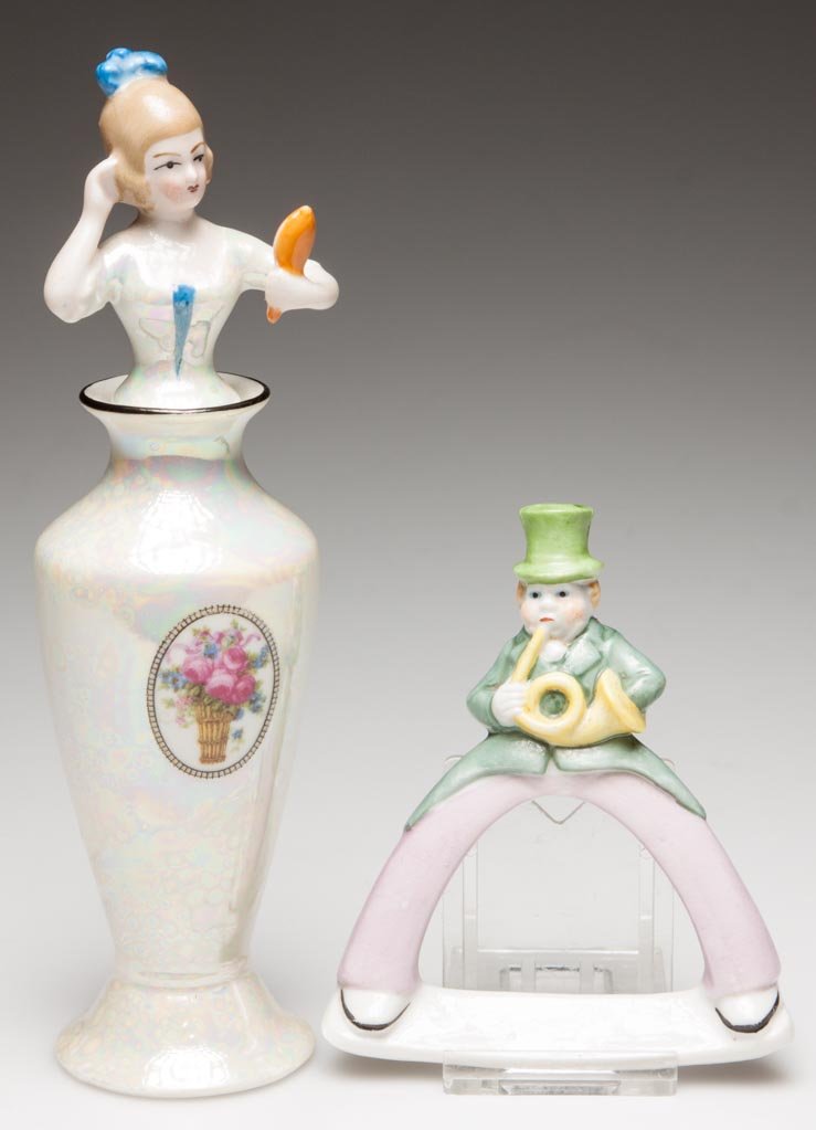 GERMAN PORCELAIN FIGURAL NOVELTY WARES A BAVARIAN TWO-P: GERMAN PORCELAIN FIGURAL NOVELTY WARES A BAVARIAN TWO-PART SCENT BOTTLE AND STOPPER, AND A CARD HOLDER, the first with a tapering baluster form, footed vase, the top formed as a female torso, admiring