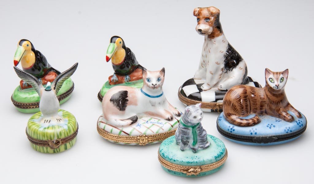 FRENCH PORCELAIN LIMOGES HAND-PAINTED LIMITED EDITION P: FRENCH PORCELAIN LIMOGES HAND-PAINTED LIMITED EDITION PILL AND MEMENTO BOXES, with gold and brass frames, the bodies formed as animals, including three cats; two toucans; another bird, and a fox terri