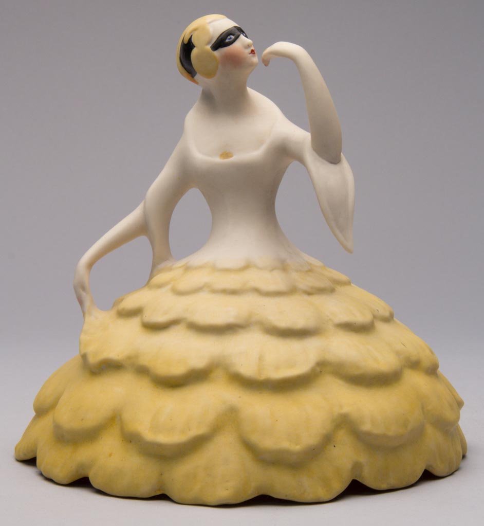 AMERICAN POTTERY FULPER POTTERY COMPANY ART DECO PORCEL: AMERICAN POTTERY FULPER POTTERY COMPANY ART DECO PORCELAIN HARLEQUIN "THE MASK" TOP TO A TWO-PART FIGURAL BOUDOIR LAMP, the top section formed as a masked flapper with a dramatic headdress over her ma
