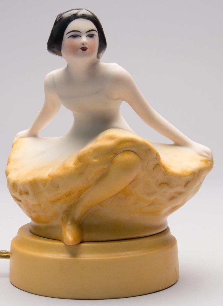 AMERICAN POTTERY FULPER POTTERY COMPANY ART DECO PORCEL: AMERICAN POTTERY FULPER POTTERY COMPANY ART DECO PORCELAIN BALLERINA TWO-PIECE FIGURAL PERFUME LAMP, with the top formed as a dancer in a deep bow, with her canary yellow tutu spreading out over her f