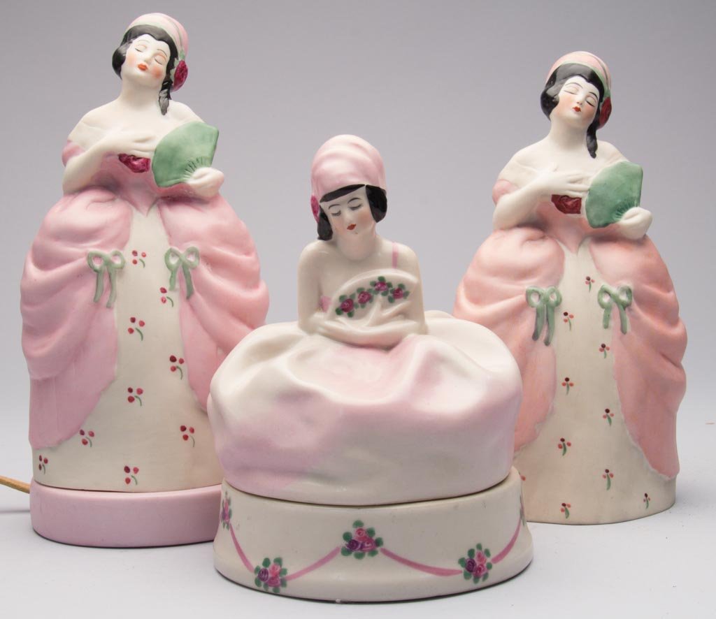 AMERICAN POTTERY FULPER POTTERY COMPANY ART DECO PORCEL: AMERICAN POTTERY FULPER POTTERY COMPANY ART DECO PORCELAIN "MME. POMPADOUR" FIGURAL TWO-PART PERFUME LAMP, and another top but lacking base; and a "Mademoiselle" figural powder jar and cover, the figu