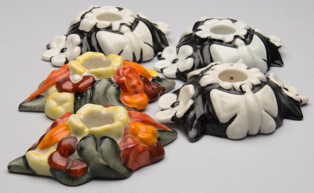 AMERICAN POTTERY FULPER POTTERY COMPANY FIVE LOW CANDLE: AMERICAN POTTERY FULPER POTTERY COMPANY FIVE LOW CANDLE STICKS, all molded to the tops, of diamond form, the first two with fruit in red and yellow hues, with dark green leaves; both with vertical pri