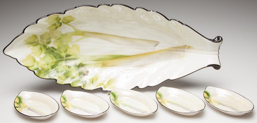 JAPANESE PORCELAIN NORITAKE PORCELAIN CELERY SET: JAPANESE PORCELAIN NORITAKE PORCELAIN CELERY SET, including a large ovular, serrated dish on foot, and five small pointed ovular dishes, all hand-painted with black line rims and stalks of celery, pri