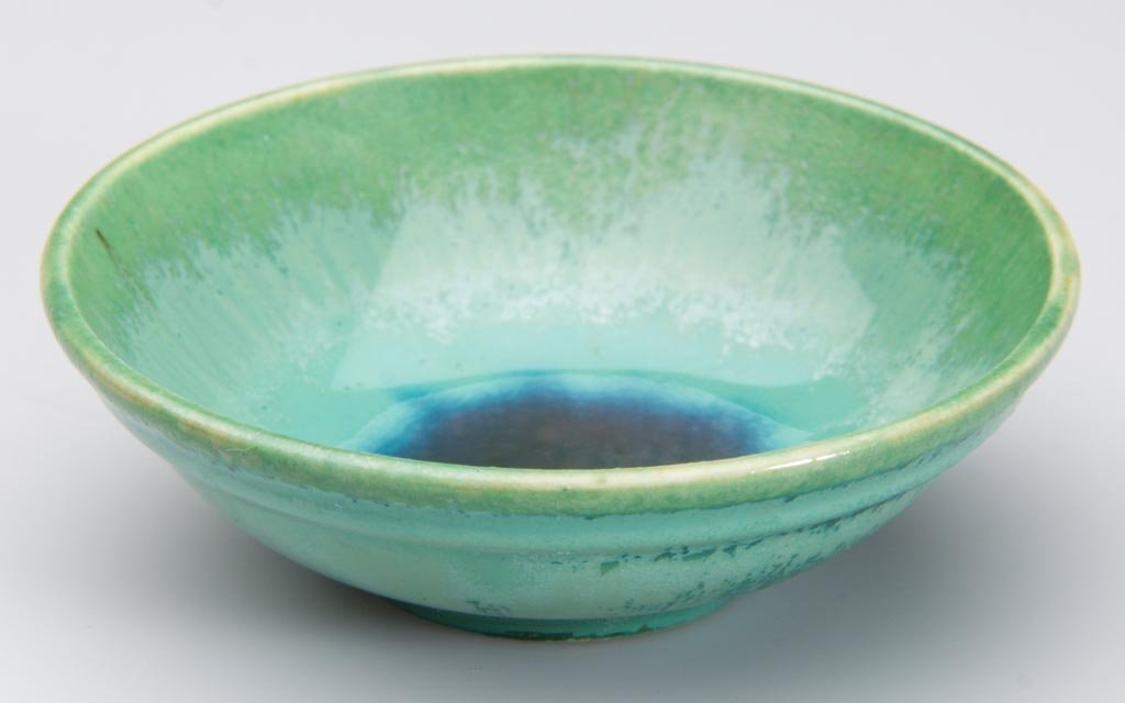 DANISH MODERN POTTERY ROYAL COPENHAGEN MINIATURE FOOTED: DANISH MODERN POTTERY ROYAL COPENHAGEN MINIATURE FOOTED BOWL, the green glaze high-fired and pooling into a dark-blue enamel field in the well, printed mountain marks, wavy lines and 3-53 to underside