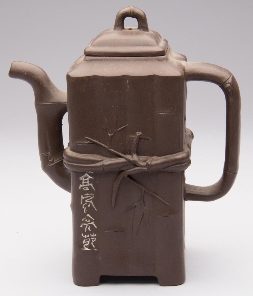 CHINESE POTTERY YIXING ZISHA CLAY ARTISTIC BROWN TEAPOT: CHINESE POTTERY YIXING ZISHA CLAY ARTISTIC BROWN TEAPOT AND COVER, in the form of a tall, rectangular bundle of bamboo shoots, tied together with thin 'roots' issuing leaves, the handle, spout and kno