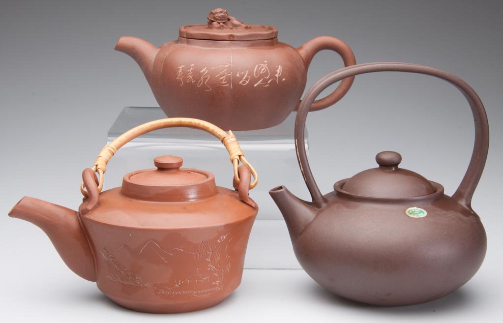 CHINESE YIXING ZISHA CLAY ARTISTIC TEAPOTS AND COVERS, : CHINESE YIXING ZISHA CLAY ARTISTIC TEAPOTS AND COVERS, LOT OF THREE, red-brown teapots, one of tapering, cylindrical form, with an interior infuser, the exterior with upright lugs to top, with arched 