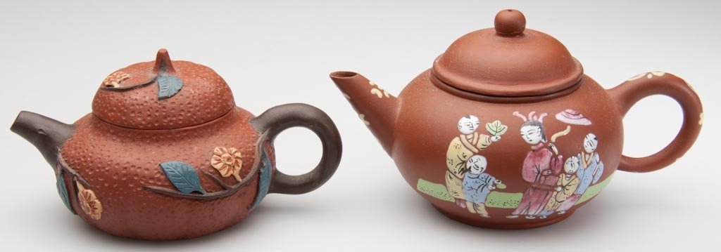 CHINESE YIXING ZISHA CLAY TWO ARTISTIC TEAPOTS AND COVE: CHINESE YIXING ZISHA CLAY TWO ARTISTIC TEAPOTS AND COVERS, the first, a small redware example with a pimpled, faux cinnabar surface , applied with taupe flowers, brown leaves and purple-brown branches