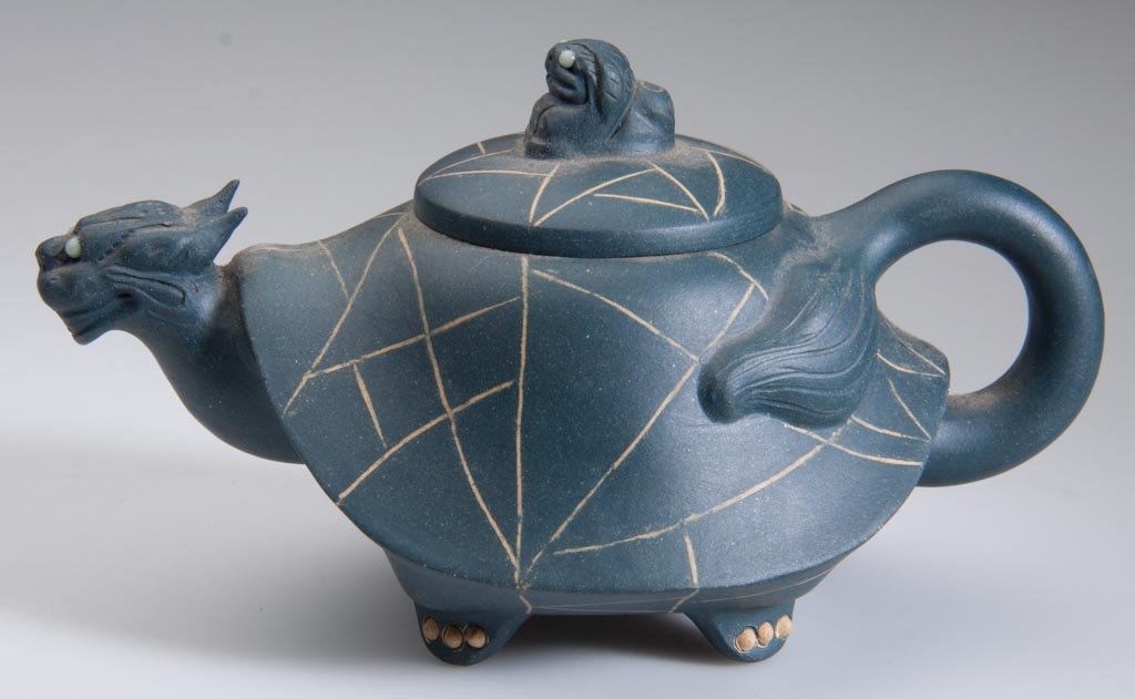 CHINESE YIXING ZISHA CLAY ARTISTIC TEAL-BLUE TEAPOT AND: CHINESE YIXING ZISHA CLAY ARTISTIC TEAL-BLUE TEAPOT AND COVER, formed as an undulating turtle's shell, with incised white lines, the spout in the form of a snail/s-head with glass-inset eyes, the hand