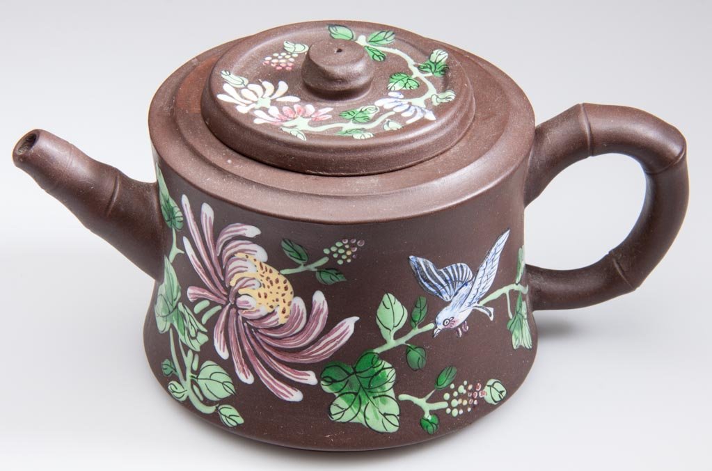 CHINESE YIXING ZISHA CLAY RED TEAPOT AND COVER: CHINESE YIXING ZISHA CLAY RED TEAPOT AND COVER, the body of slightly-waisted and flaring, cylindrical form, with faux bamboo handle and spout, with flat cover and flat button knop, the sides and top p