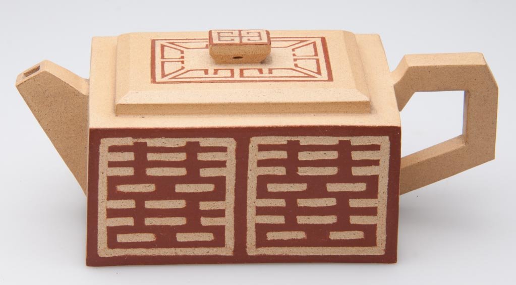 CHINESE YIXING ZISHA CLAY ARTISTIC MINIATURE LIGHT-BROW: CHINESE YIXING ZISHA CLAY ARTISTIC MINIATURE LIGHT-BROWN TEAPOT AND COVER, the low, rectangular body with square notched spout and handle, the stepped cover with rectangular knop; the sides and top im