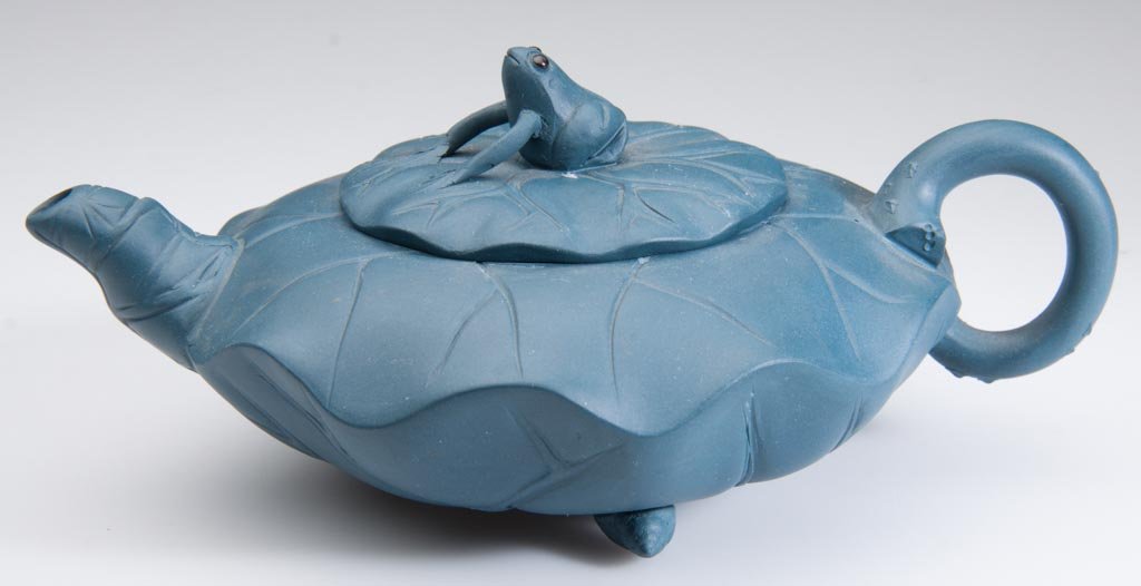 CHINESE YIXING ZISHA CLAY, JIANG YUNG, ARTIST ARTISTIC : CHINESE YIXING ZISHA CLAY, JIANG YUNG, ARTIST ARTISTIC TEAL-BLUE TEAPOT AND COVER, "FROG ON LOTUS", the body formed as an undulating lily pad, the frog-form knop on the cover with glass-inset eyes, im