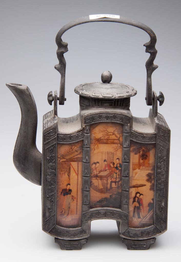 THAILAND, CHINESE-STYLE TEAPOT AND COVER: THAILAND, CHINESE-STYLE TEAPOT AND COVER, the body formed of metal, molded with geometric and foliate motifs, of incurvate rectangular form, on two feet, with two flanges holding the molded spout, wit