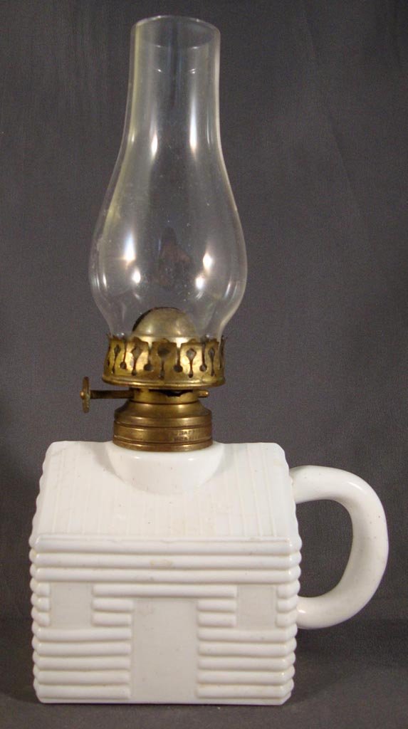 LOG CABIN / SCHOOL HOUSE FINGER LAMP - LARGE: LOG CABIN / SCHOOL HOUSE FINGER LAMP - LARGE, opaque white, No. 1 Taplin-Brown collar with patent information. Fitted with a period burner marked "The Little Wizard". Atterbury & Co. Fourth quarter 19