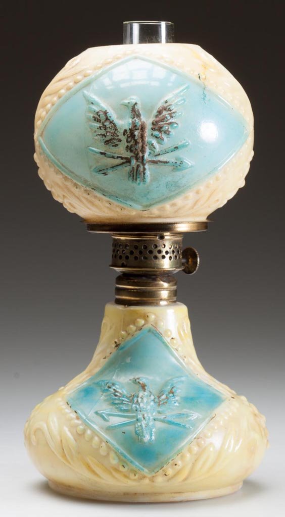 EAGLE MINIATURE LAMP: EAGLE MINIATURE LAMP, opaque white with fired yellow and blue decoration and gold trim, embossed "Eagle" on base, with matching ball shade. Period burner. Eagle Glass & Manufacturing Co. Fourth quarte