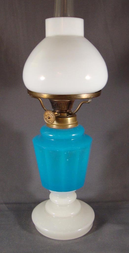 PANELED MINIATURE LAMP: PANELED MINIATURE LAMP, blue opaline and clambroth, footed base, white Bristol glass fitterless shade. Period burner and chimney. Fourth quarter 19th/early 20th century. 9 3/8" H to top of shade, 5 1/