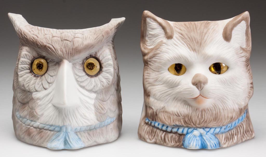 GERMAN BISQUE FIGURAL NURSERY / FAIRY LAMPS, LOT OF TWO: GERMAN BISQUE FIGURAL NURSERY / FAIRY LAMPS, LOT OF TWO, polychrome decoration, comprising a owl and a cat, each with inset eyes of unknown association and a blue rope with tassels below face, no mark