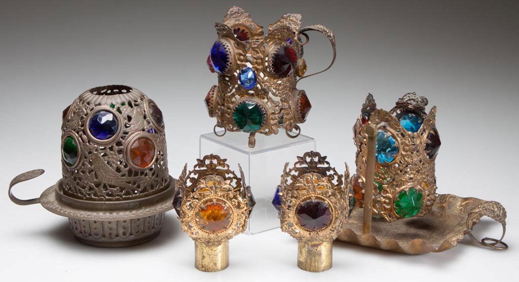 JEWELED STAMPED-BRASS FAIRY LAMPS AND RELATED ARTICLES,: JEWELED STAMPED-BRASS FAIRY LAMPS AND RELATED ARTICLES, LOT OF FIVE, each set with colored-glass faceted jewels, comprising three hand lamps, one with swinging holder, and two candle shades, some with