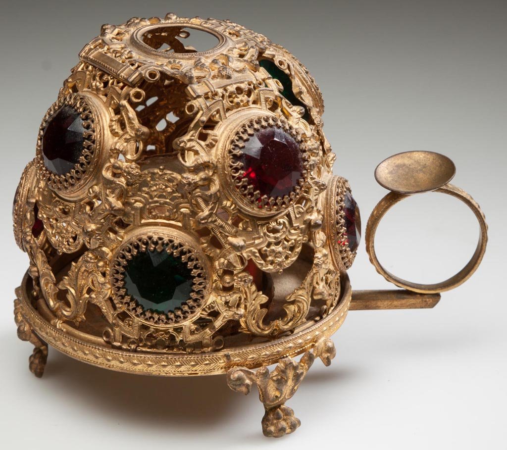 JEWELED ORMOLU FAIRY LAMP: JEWELED ORMOLU FAIRY LAMP, finely detailed dome set with colored-glass faceted jewels, on original base with finger ring and three paw feet, Clarke's "Pyramid" candle. Fourth quarter 19th century. 3 3