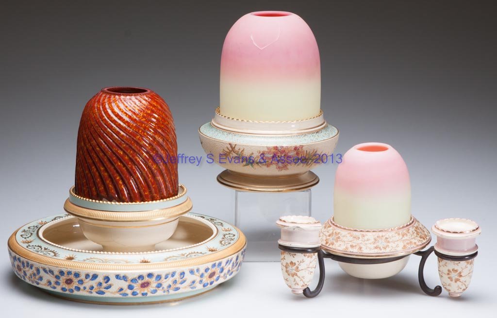 BURMESE AND CERAMIC FAIRY LAMPS, LOT OF THREE: BURMESE AND CERAMIC FAIRY LAMPS, LOT OF THREE, comprising two fairy-size and one pyramid-size dome fitted on different polychrome decorated Tapestry Ware bases marked for Taylor, Tunnicliffe & Co., on
