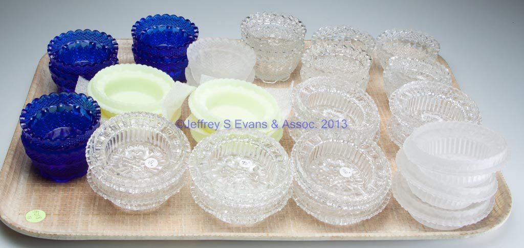 ASSORTED FAIRY LAMP CUPS, LOT OF 33: ASSORTED FAIRY LAMP CUPS, LOT OF 33, colored and colorless, odd- and fairy-size, most marked for Fenton. Second half 20th century. Various sizes. Provenance: Collection of Lloyd and Nannette Graham.