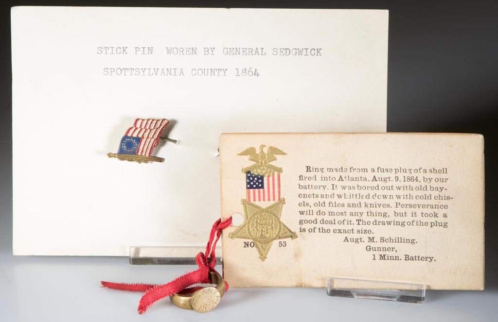 CIVIL WAR RELATED JEWELRY, LOT OF TWO: CIVIL WAR RELATED JEWELRY, LOT OF TWO, comprising a brass ring engraved "ATLANTA 1864" and with original printed card indicating "Ring made from a fuse plug of a shell fired into Atlanta, Augt. 9, 186