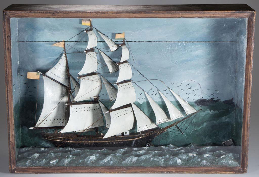 AMERICAN FOLK ART CARVED AND PAINTED SHIP DIORAMA: AMERICAN FOLK ART CARVED AND PAINTED SHIP DIORAMA, depicting the three-masted bark "Hugo" with American flag in rolling seas with spouting whales in the background, old label "Edith Reid" on pine back