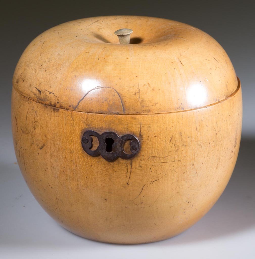 GEORGE III FRUITWOOD APPLE-FORM TEA CADDY: GEORGE III FRUITWOOD APPLE-FORM TEA CADDY, hinged lid with later stem, pierced escutcheon, interior with remnants of foil lining. Late 18th century. 4" H, 4 1/2" D. Provenance: Property of a Virginia 